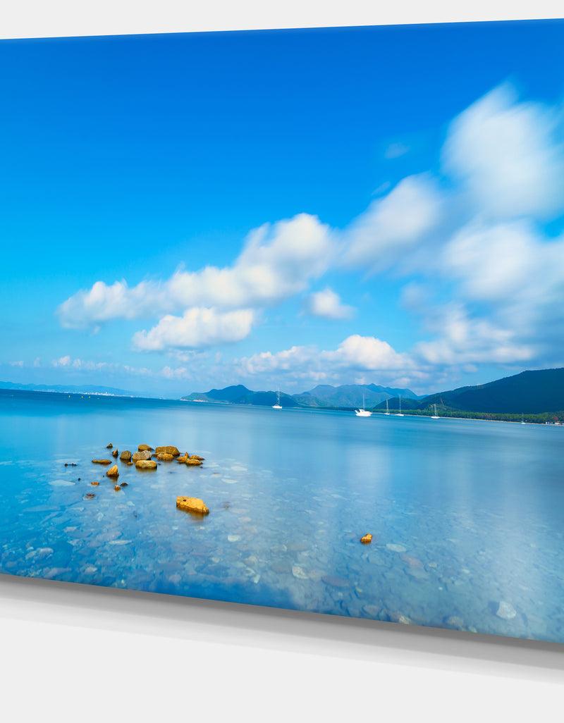 DesignQ Rocks In A Blue Panoramic Sea Bay - Extra Large Seashore Canvas Art